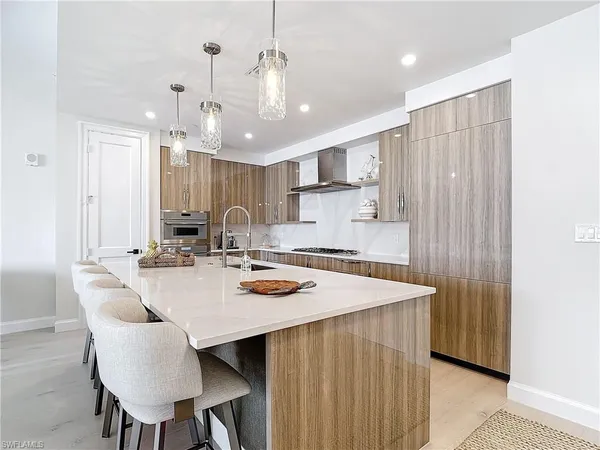 a kitchen with a dining table chairs and white cabinets