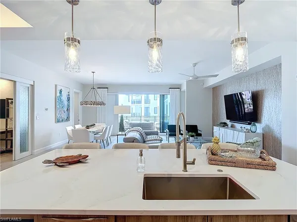 a living room with furniture a window and a flat screen tv