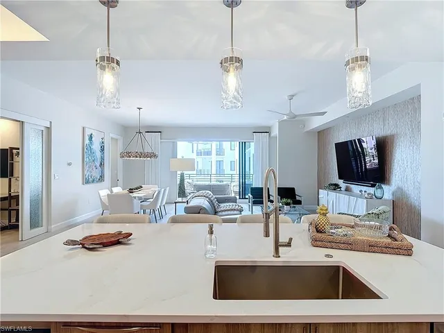 a living room with furniture a window and a flat screen tv