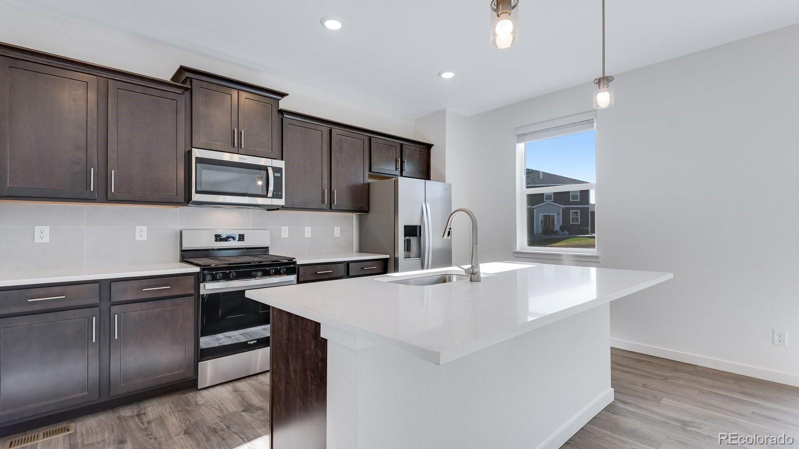 3434 Belleville Ridge Road Elizabeth, CO 80107 - Photo 13 of 48 a kitchen with stainless steel appliances granite countertop a sink stove and refrigerator