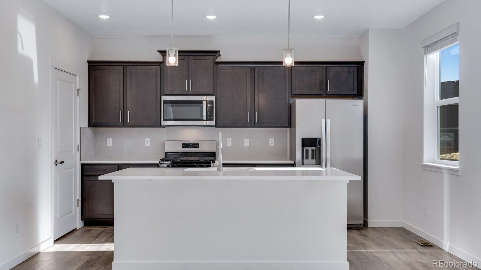 3434 Belleville Ridge Road Elizabeth, CO 80107 - Photo 14 of 48 a kitchen with stainless steel appliances granite countertop a refrigerator stove top oven and sink
