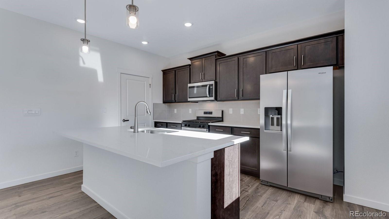 3434 Belleville Ridge Road Elizabeth, CO 80107 - Photo 15 of 48 a kitchen with kitchen island a counter top space cabinets and stainless steel appliances