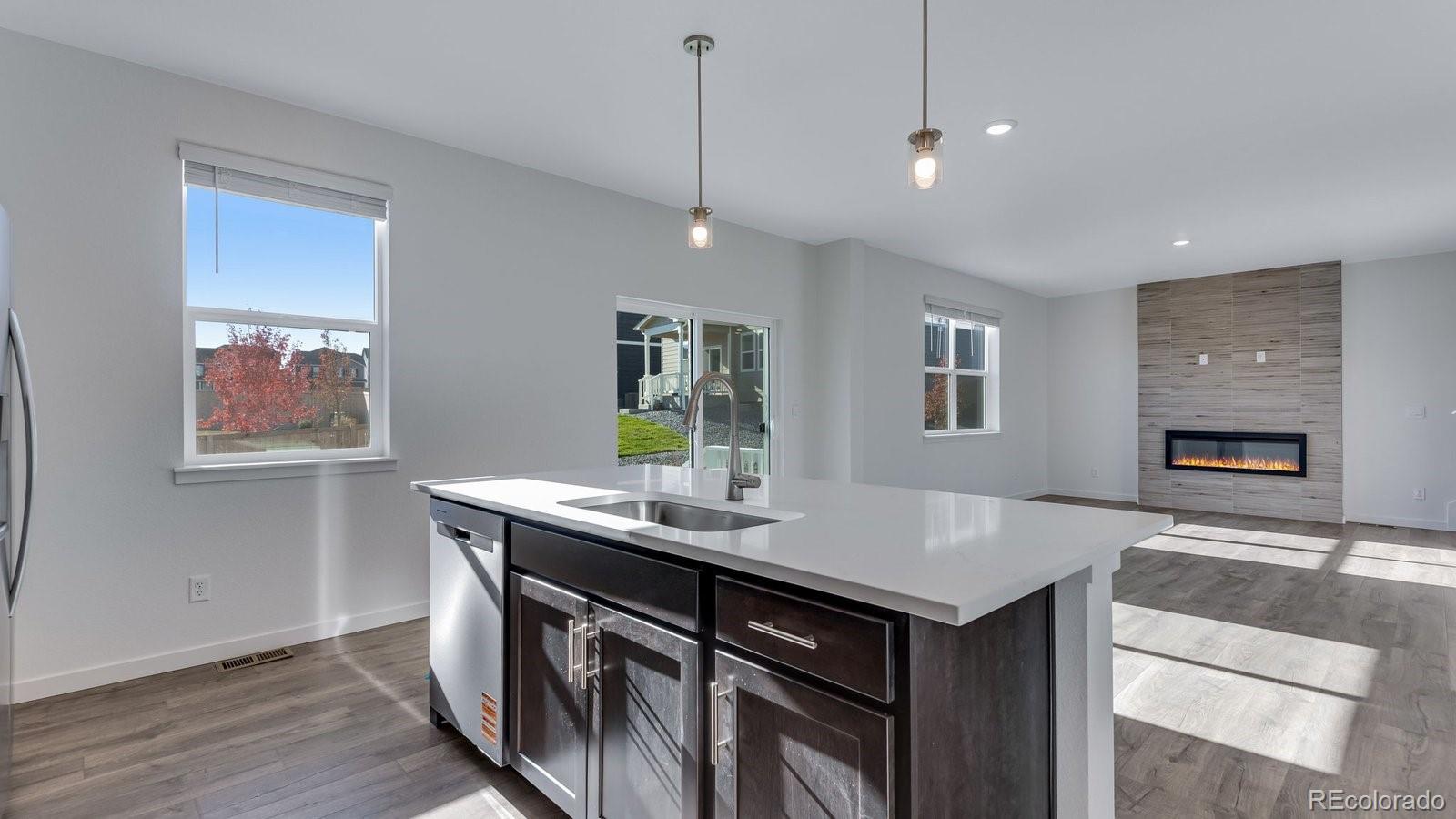 3434 Belleville Ridge Road Elizabeth, CO 80107 - Photo 17 of 48 a kitchen with a sink stove and wooden floor