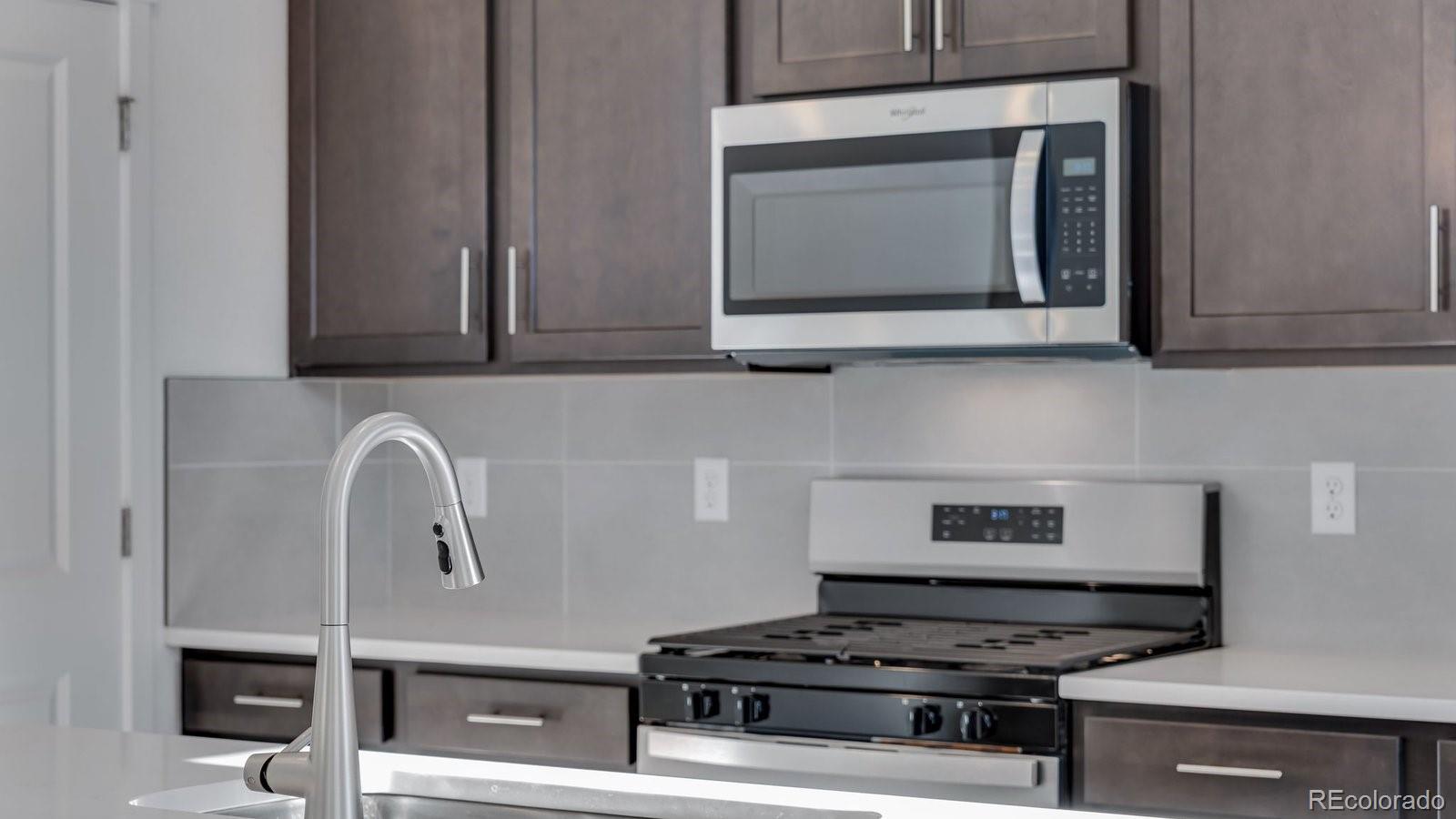 3434 Belleville Ridge Road Elizabeth, CO 80107 - Photo 19 of 48 a kitchen with a stove and a microwave
