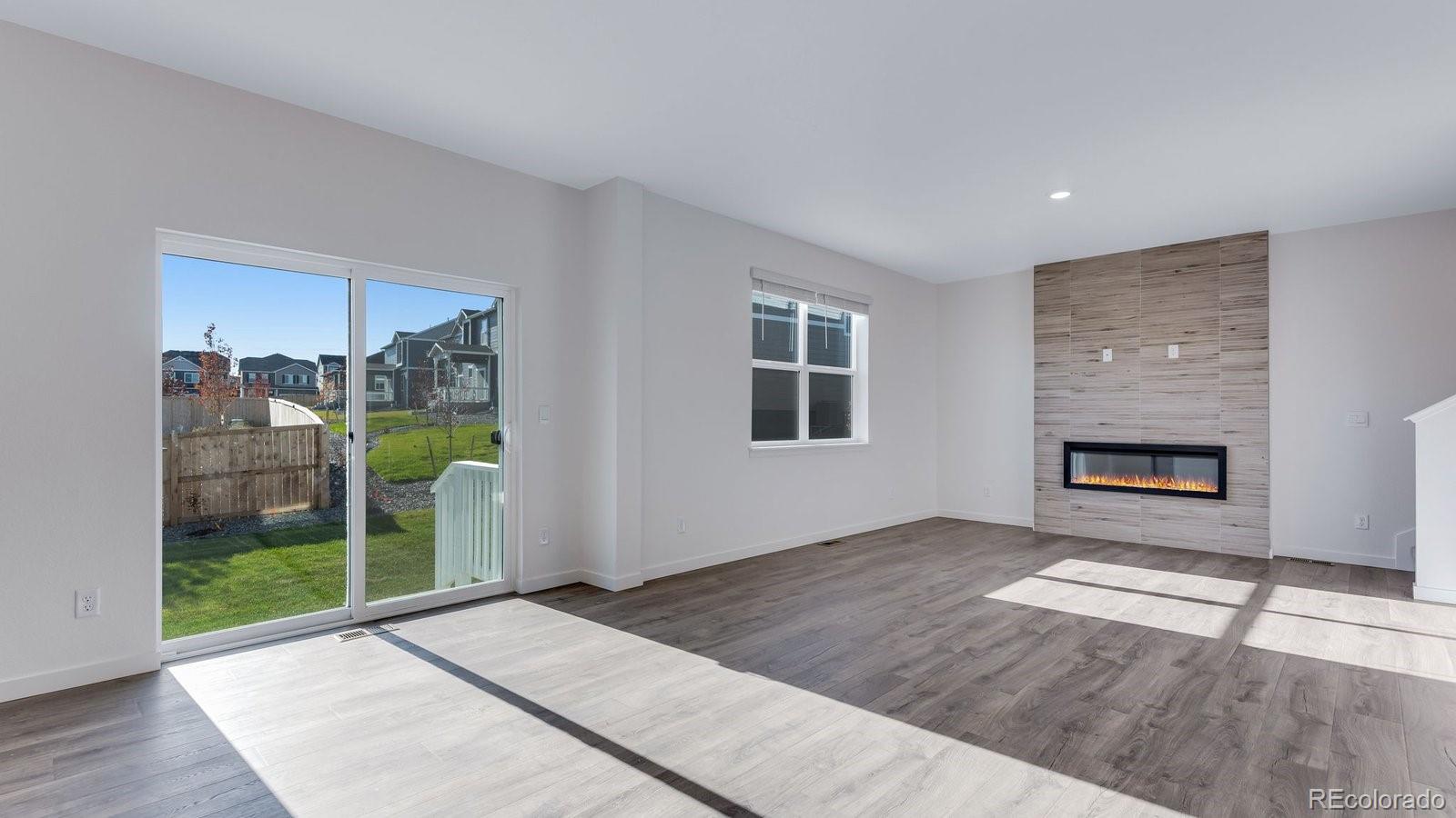 3434 Belleville Ridge Road Elizabeth, CO 80107 - Photo 22 of 48 an empty room with windows and fireplace
