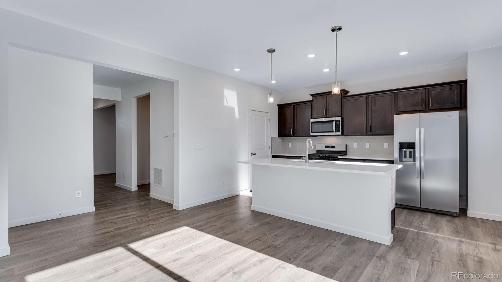 3434 Belleville Ridge Road Elizabeth, CO 80107 - Photo 24 of 48 a kitchen with stainless steel appliances a refrigerator sink and microwave