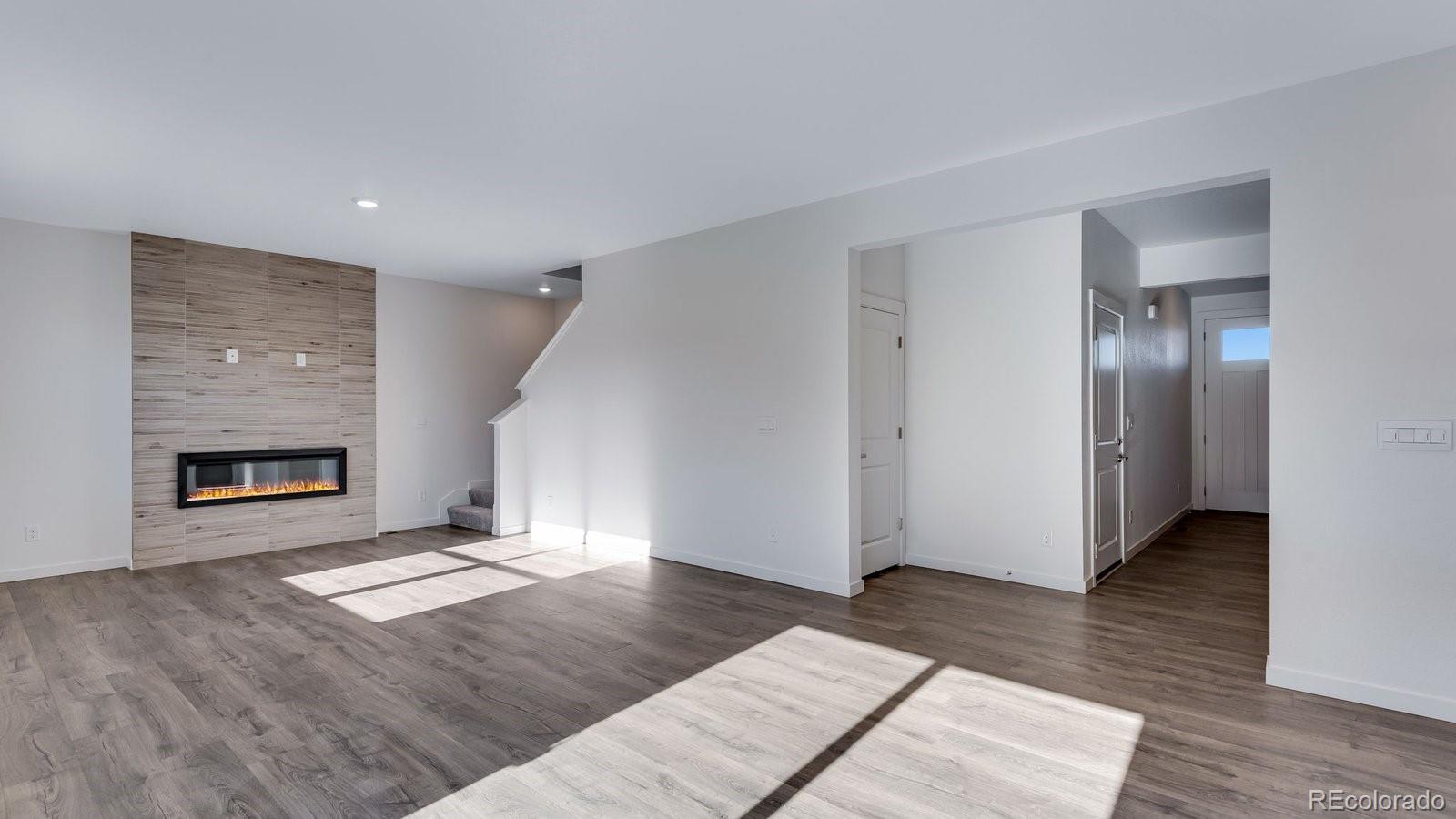 3434 Belleville Ridge Road Elizabeth, CO 80107 - Photo 25 of 48 a view of livingroom with hardwood floor and a fireplace