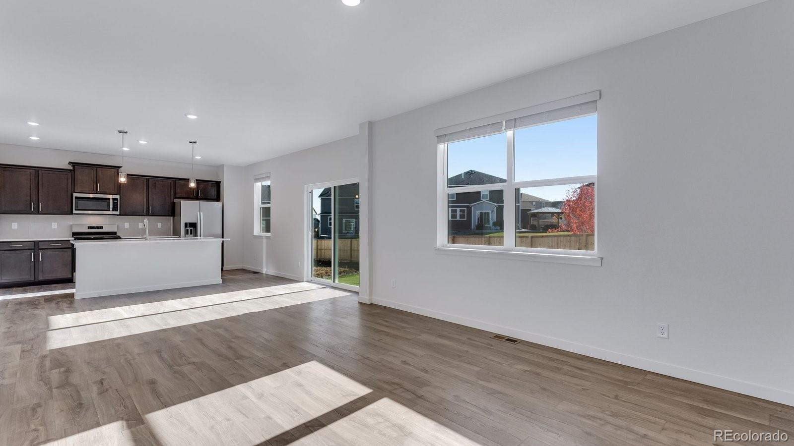 3434 Belleville Ridge Road Elizabeth, CO 80107 - Photo 29 of 48 a view of kitchen with granite countertop cabinets and wooden floor