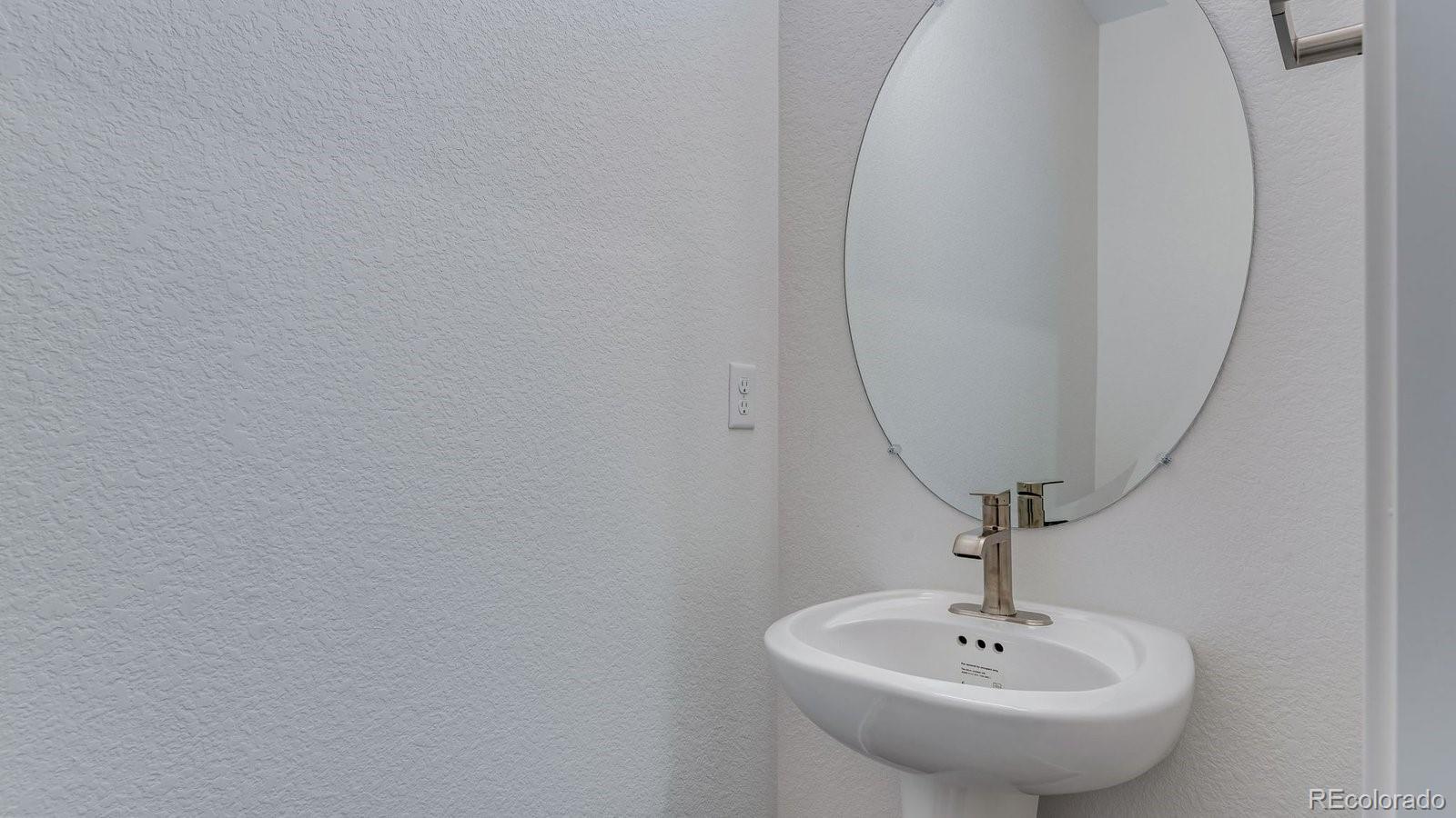 3434 Belleville Ridge Road Elizabeth, CO 80107 - Photo 30 of 48 a bathroom with a sink and a mirror