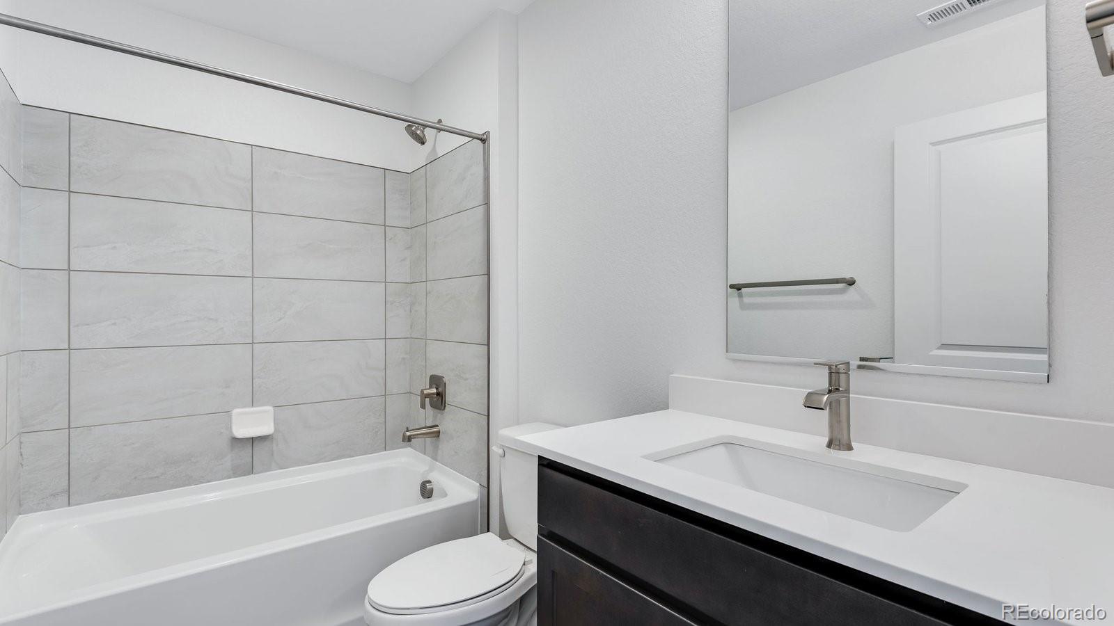 3434 Belleville Ridge Road Elizabeth, CO 80107 - Photo 34 of 48 a bathroom with a sink toilet a bathtub and shower