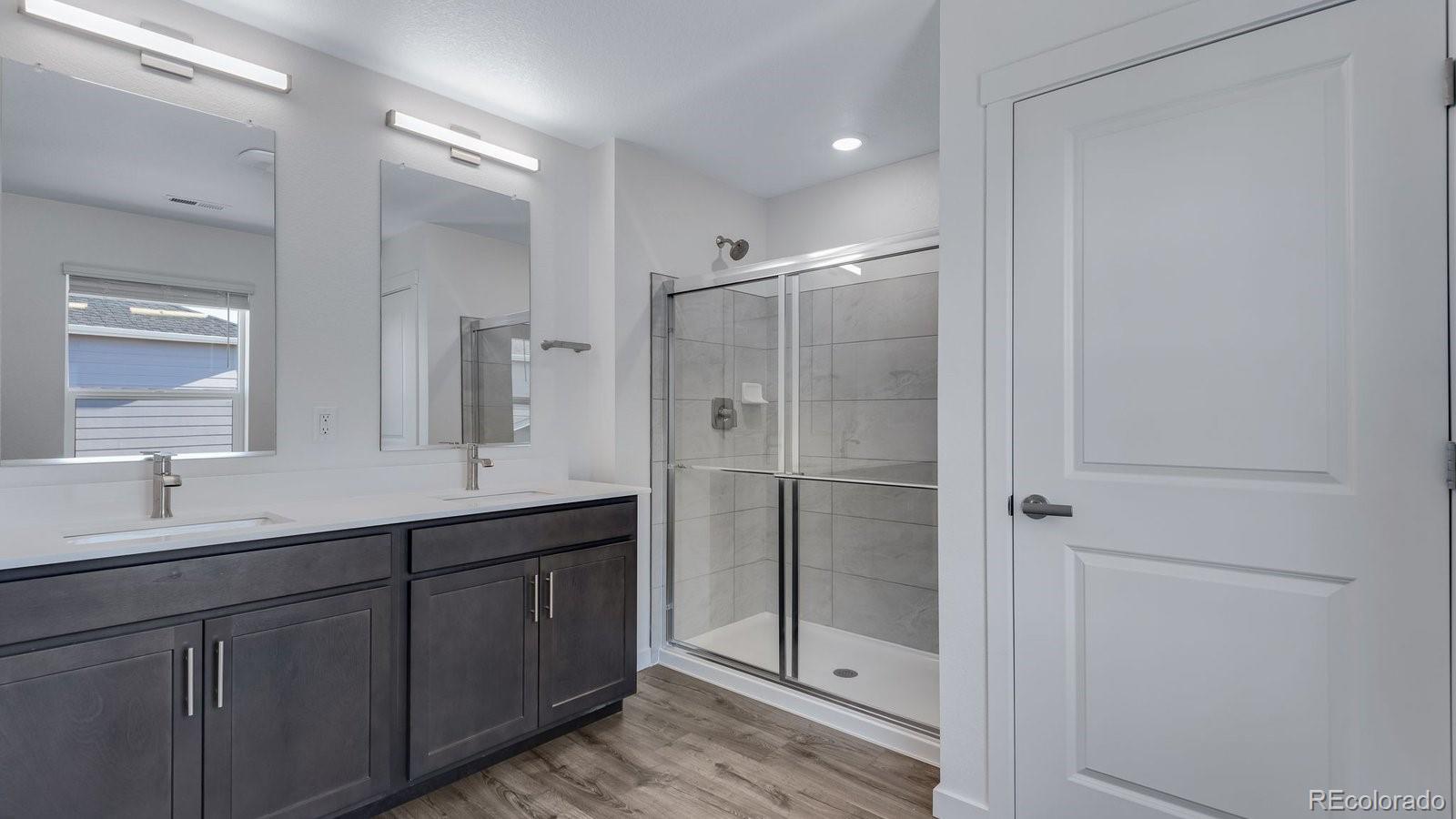 3434 Belleville Ridge Road Elizabeth, CO 80107 - Photo 44 of 48 a bathroom with a double vanity sink mirror and double
