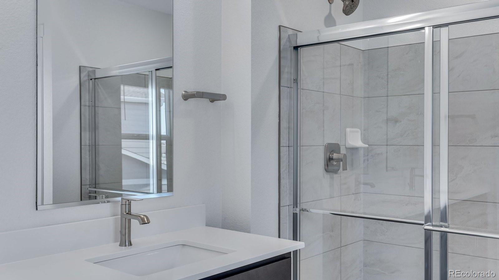 3434 Belleville Ridge Road Elizabeth, CO 80107 - Photo 47 of 48 a bathroom with a sink and a mirror