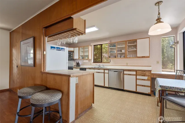 a kitchen with granite countertop a sink cabinets and window