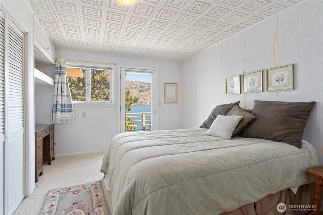 a bedroom with a large bed and a window