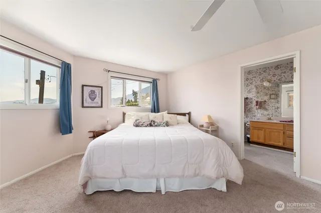 a bedroom with a large bed and a chandelier