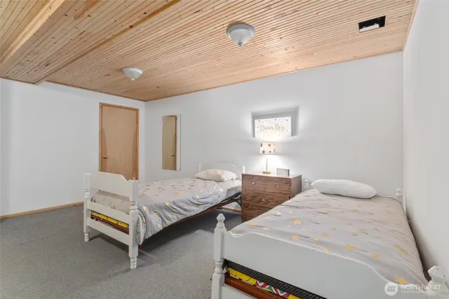 a bedroom with two beds and a window