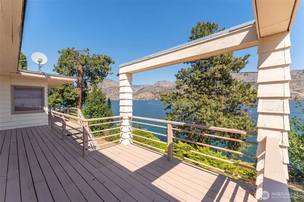 a view of a balcony with wooden floor and bench