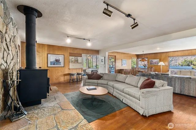 a living room with furniture a rug and a chandelier