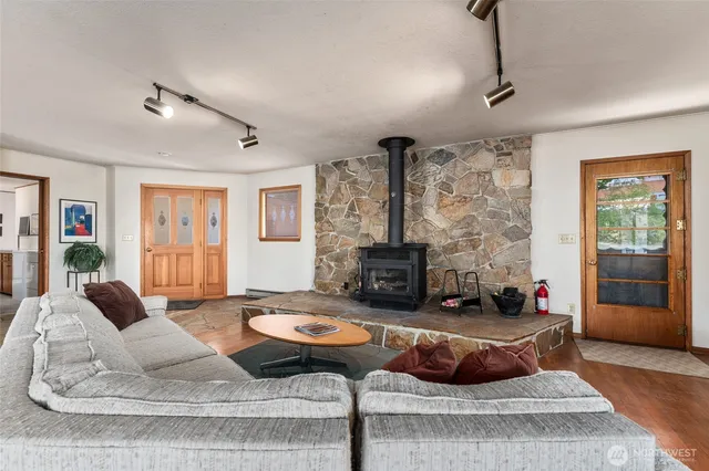 a living room with furniture and wooden floor