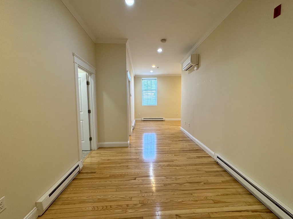 3 Main Street, Unit 201 Peabody, MA 01960 - Photo 2 of 10 a view of an empty room with wooden floor