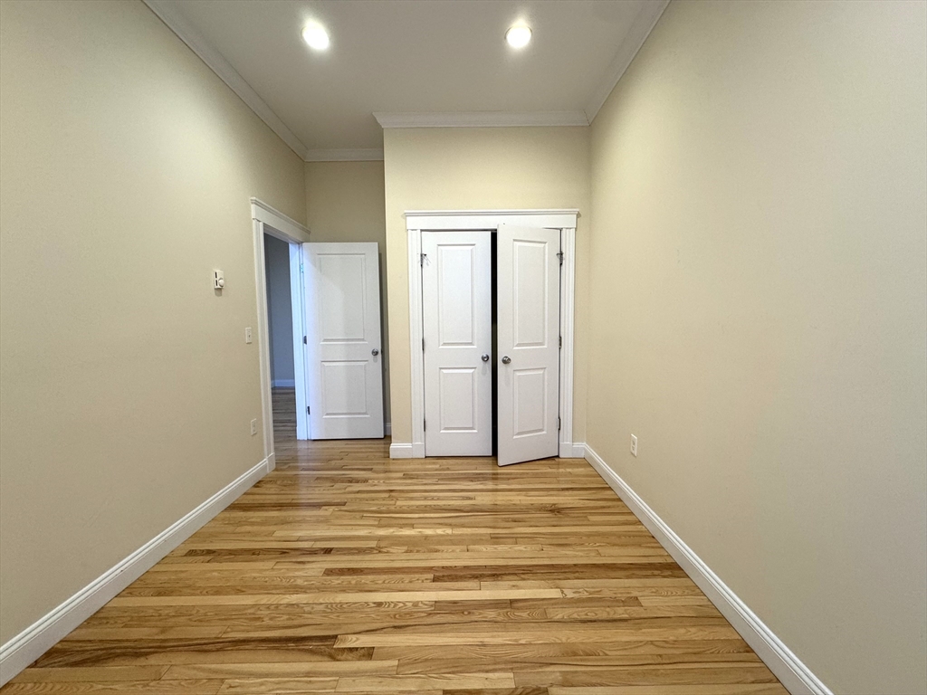 3 Main Street, Unit 201 Peabody, MA 01960 - Photo 4 of 10 a view of an empty room with wooden floor