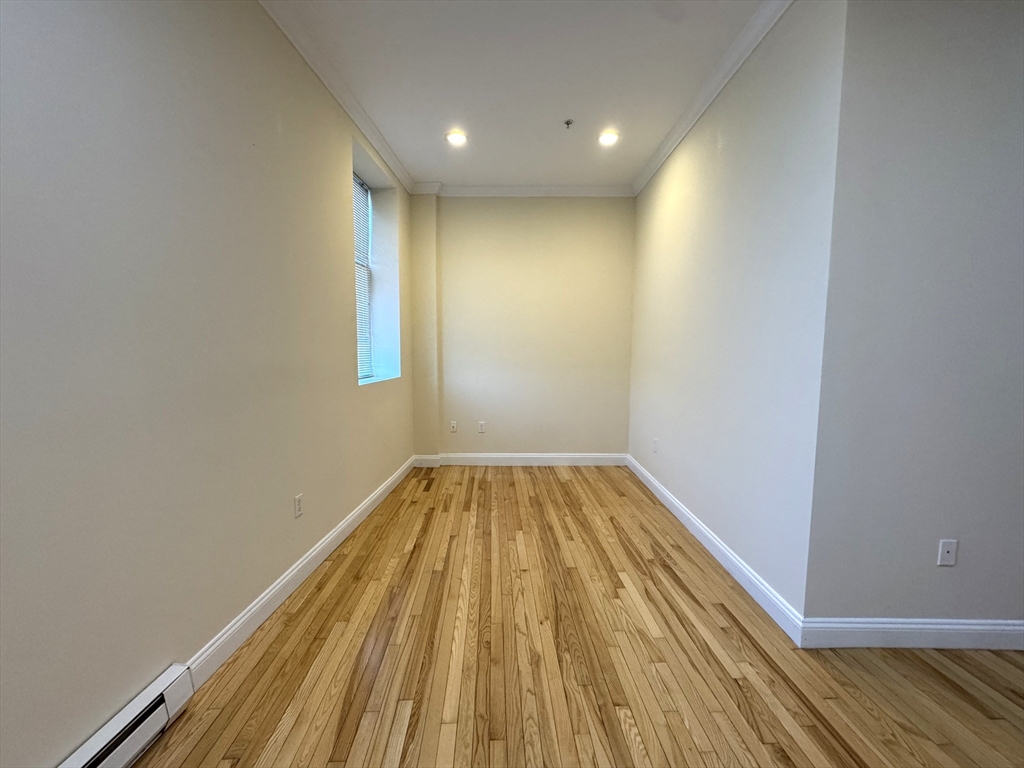 3 Main Street, Unit 201 Peabody, MA 01960 - Photo 5 of 10 a view of wooden floor in a room