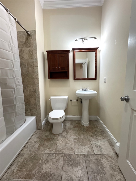 3 Main Street, Unit 201 Peabody, MA 01960 - Photo 8 of 10 a bathroom with a toilet a sink and bathtub