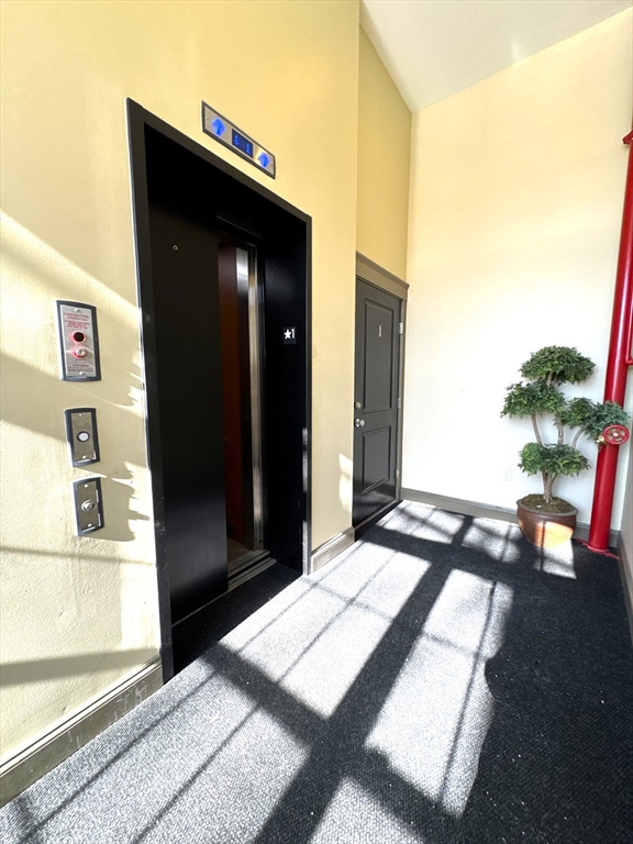 3 Main Street, Unit 201 Peabody, MA 01960 - Photo 10 of 10 a living room with a bed and furniture