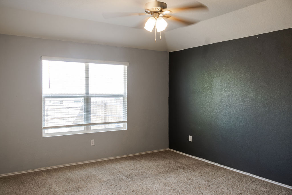 14915 Talus Road Manor, TX 78653 - Photo 10 of 20 Plush carpeting anchors this quiet bedroom space underneath a classic tray ceiling.