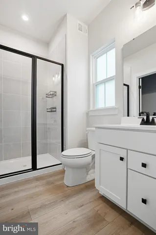 a bathroom with a toilet a sink and a mirror