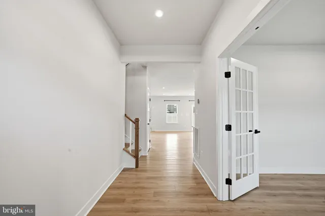 a view of a hallway with wooden floor