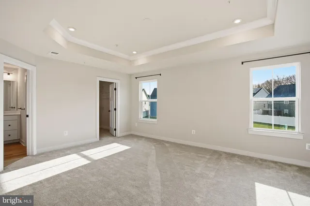 an empty room with windows and closet