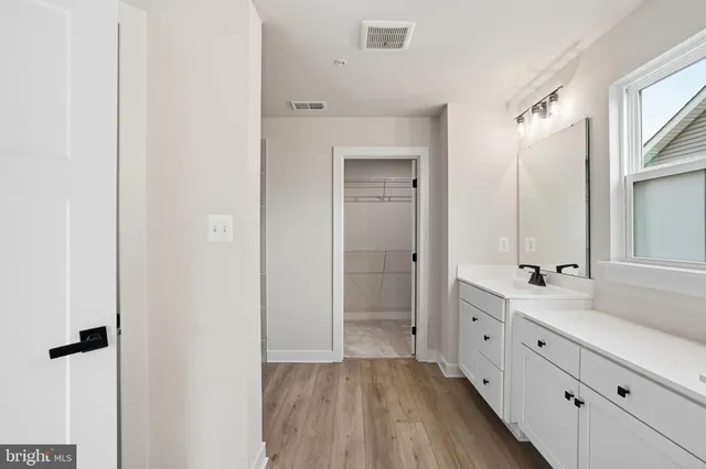 a bathroom with a double vanity sink mirror and shower