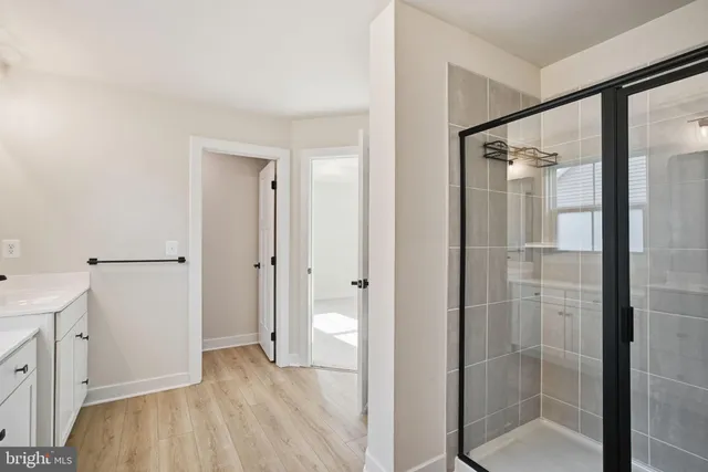 a bathroom with a shower and a glass door