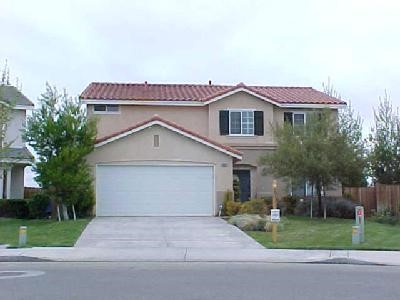 14683 Foothill Road Victorville, CA 92394 - Photo 1 of 1 a front view of a house with a yard and garage