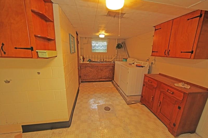 4470 Mt Troy Road Pittsburgh, PA 15214 - Photo 20 of 20 Laundry Room with Deep Sinks, Lots of Cabinets and a Folding Surface