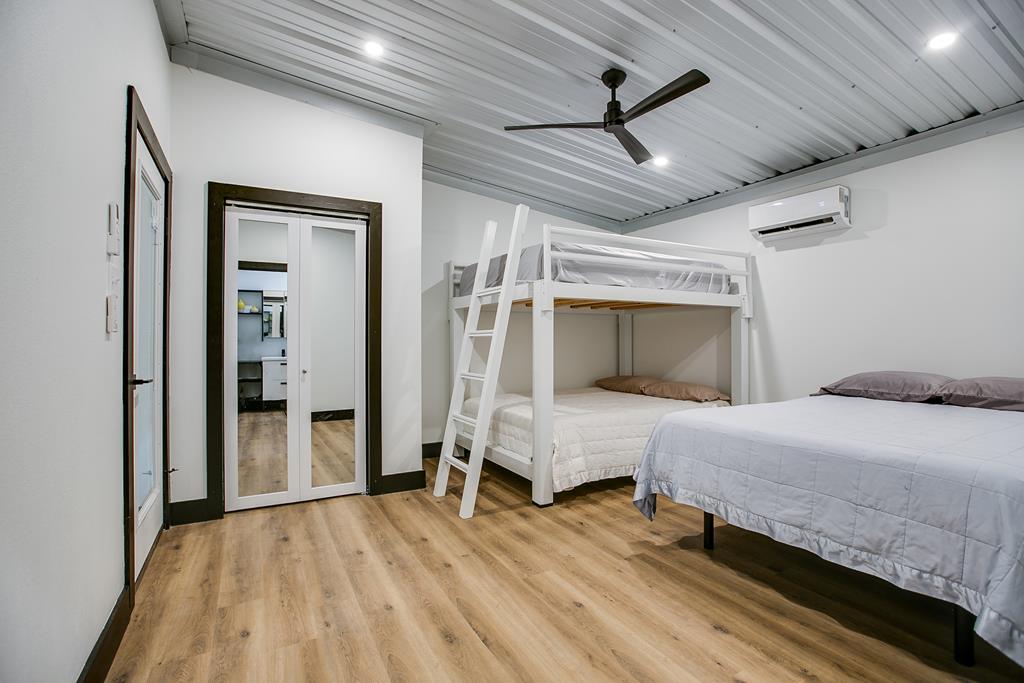 19621 Bluff Road Christoval, TX 76935 - Photo 17 of 74 a bedroom with a bed and a ceiling fan