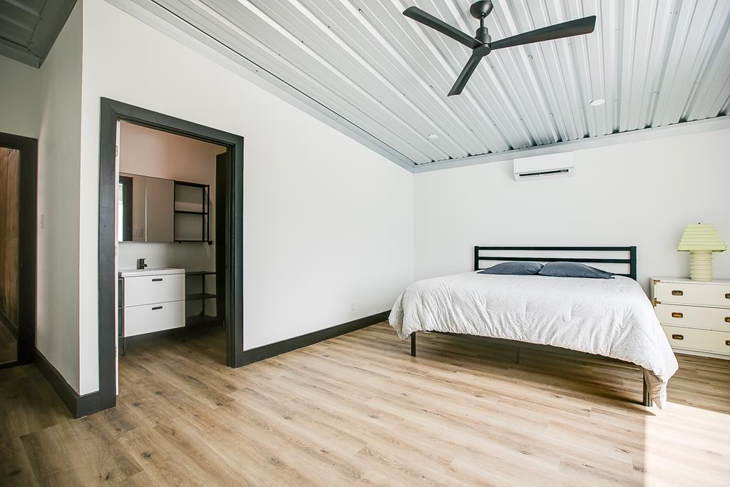 19621 Bluff Road Christoval, TX 76935 - Photo 22 of 74 a bedroom with a bed and wooden floor