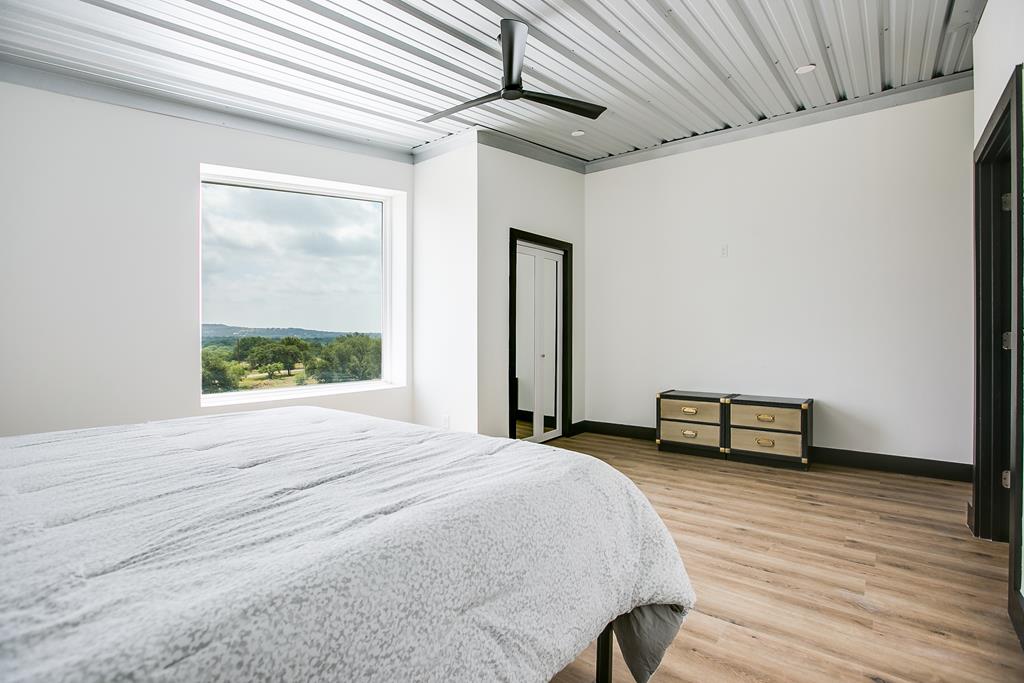 19621 Bluff Road Christoval, TX 76935 - Photo 23 of 74 a bedroom with a bed and a window