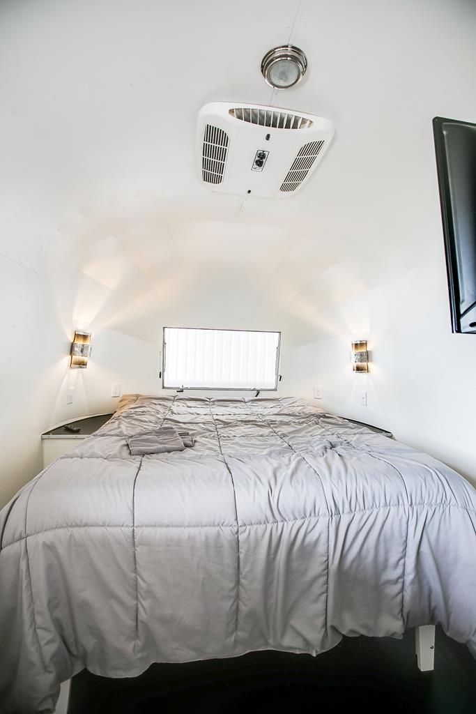 19621 Bluff Road Christoval, TX 76935 - Photo 52 of 74 a bedroom with a bed and painting on the wall