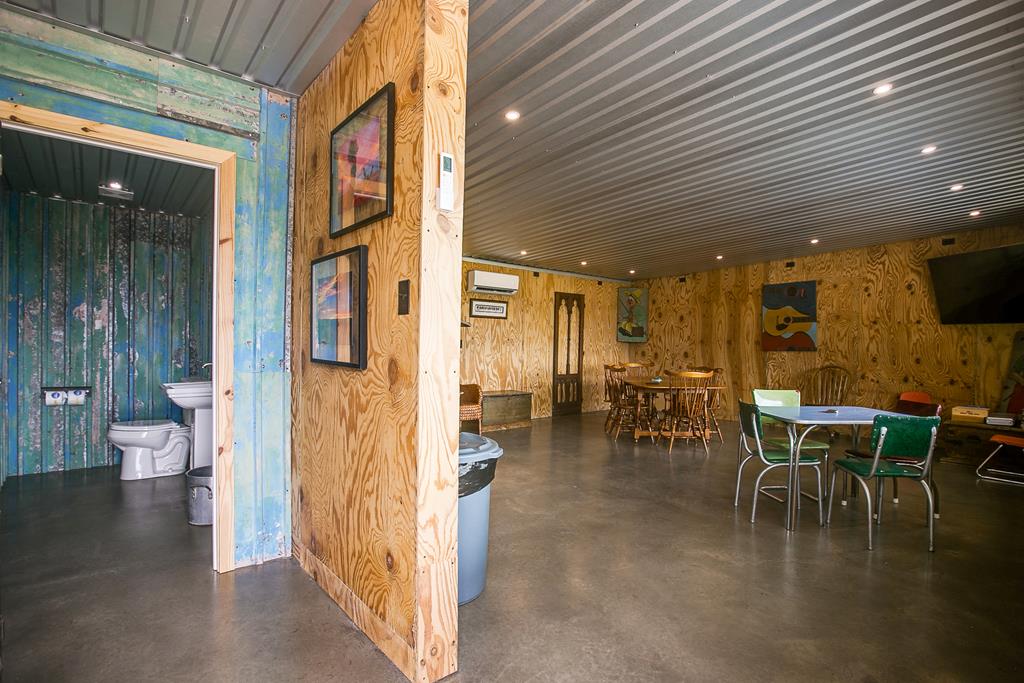 19621 Bluff Road Christoval, TX 76935 - Photo 56 of 74 a dining hall with couches a dining table and chairs with wooden floor