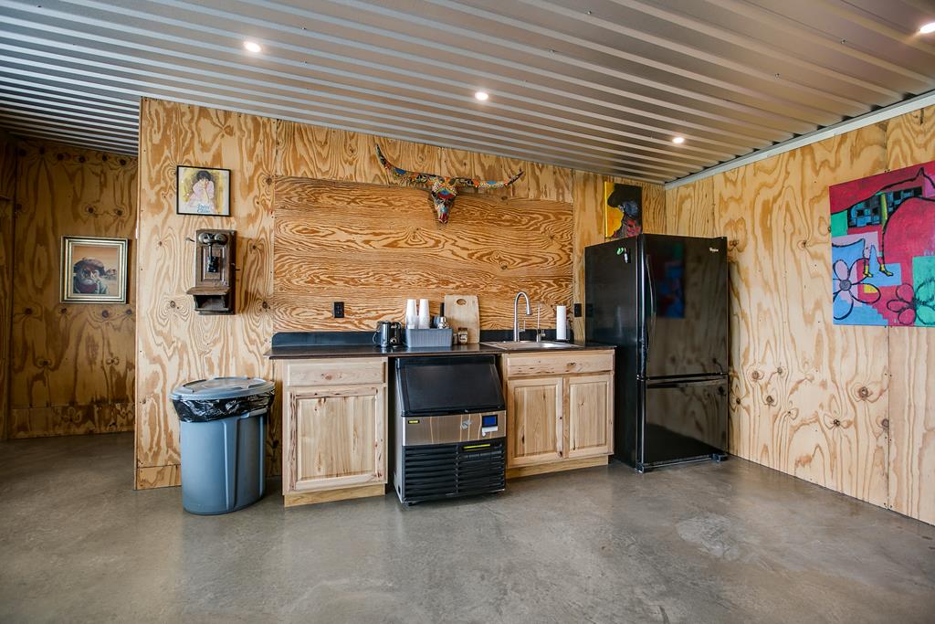 19621 Bluff Road Christoval, TX 76935 - Photo 60 of 74 a kitchen with stainless steel appliances kitchen island granite countertop a refrigerator and a stove