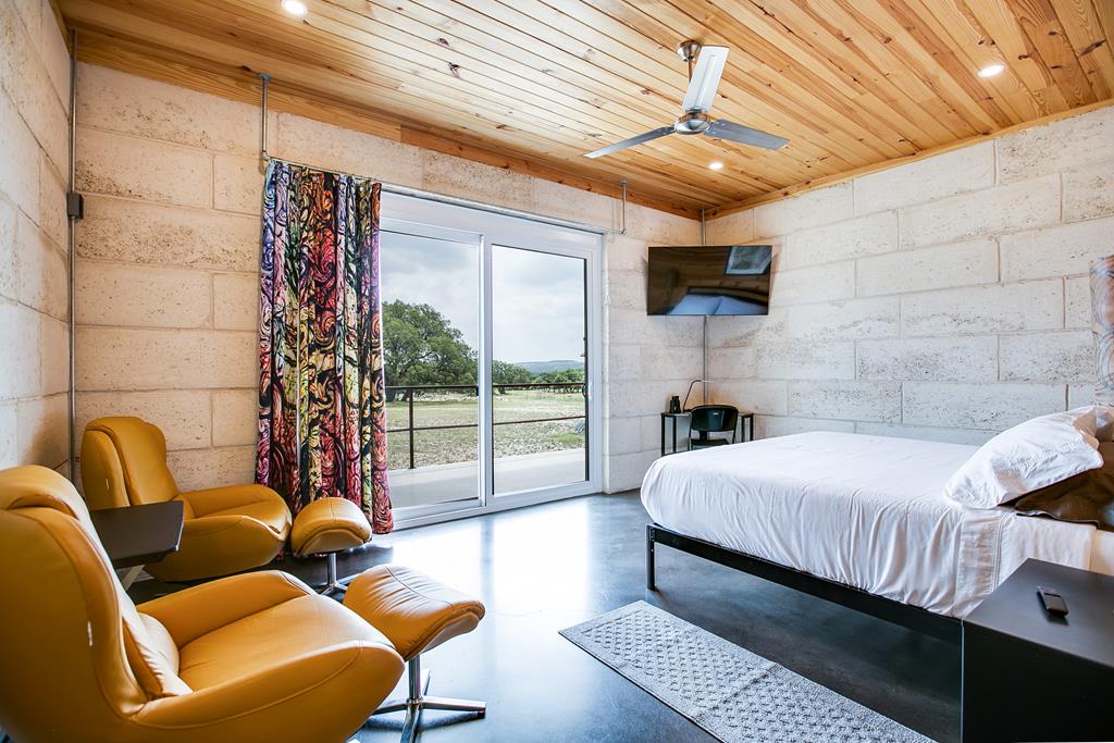 19621 Bluff Road Christoval, TX 76935 - Photo 67 of 74 a bedroom with furniture and a fireplace