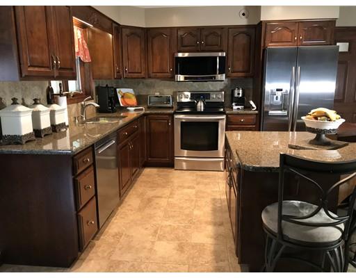 11 Dotys Mill Road Acushnet, MA 02743 - Photo 7 of 26 a kitchen with stainless steel appliances kitchen island granite countertop a sink a stove and a microwave