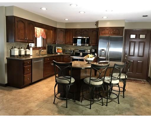 11 Dotys Mill Road Acushnet, MA 02743 - Photo 8 of 26 a kitchen with stainless steel appliances kitchen island granite countertop a table chairs sink and cabinets