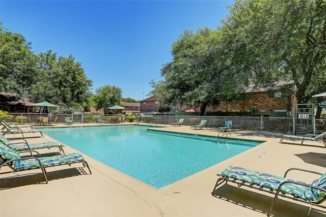 a view of a swimming pool with lounge chair