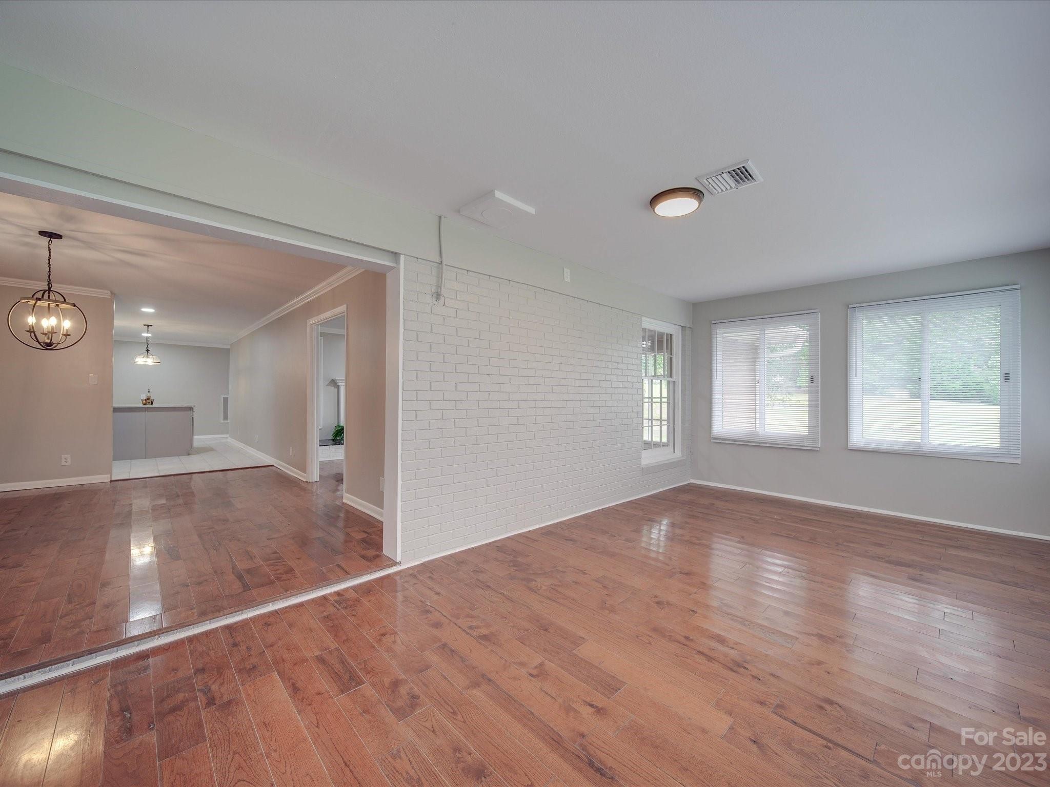 1035 Blake Road Albemarle, NC 28001 - Photo 11 of 45 a view of an empty room and window and wooden floor