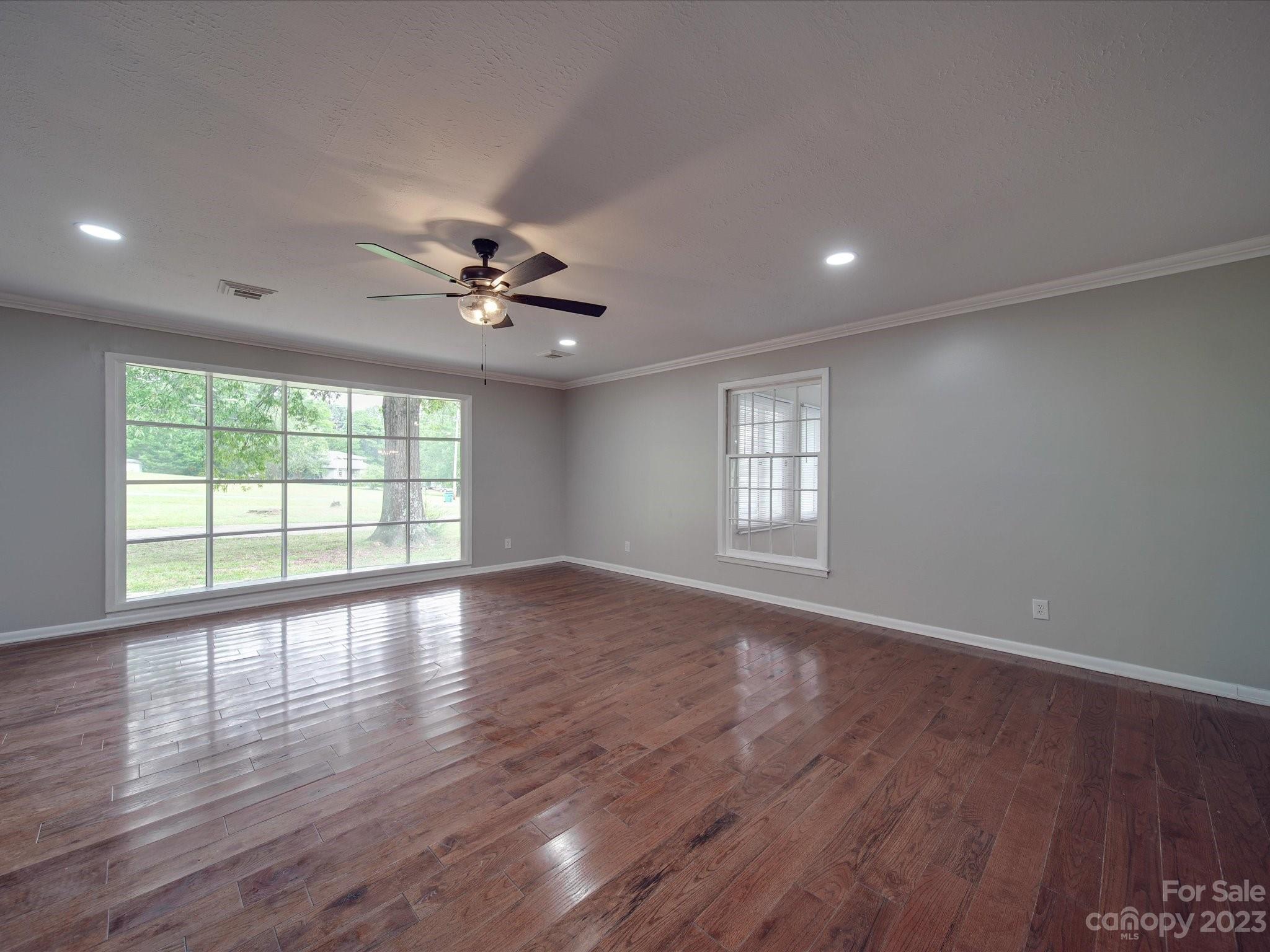 1035 Blake Road Albemarle, NC 28001 - Photo 13 of 45 a view of an empty room with wooden floor and a window