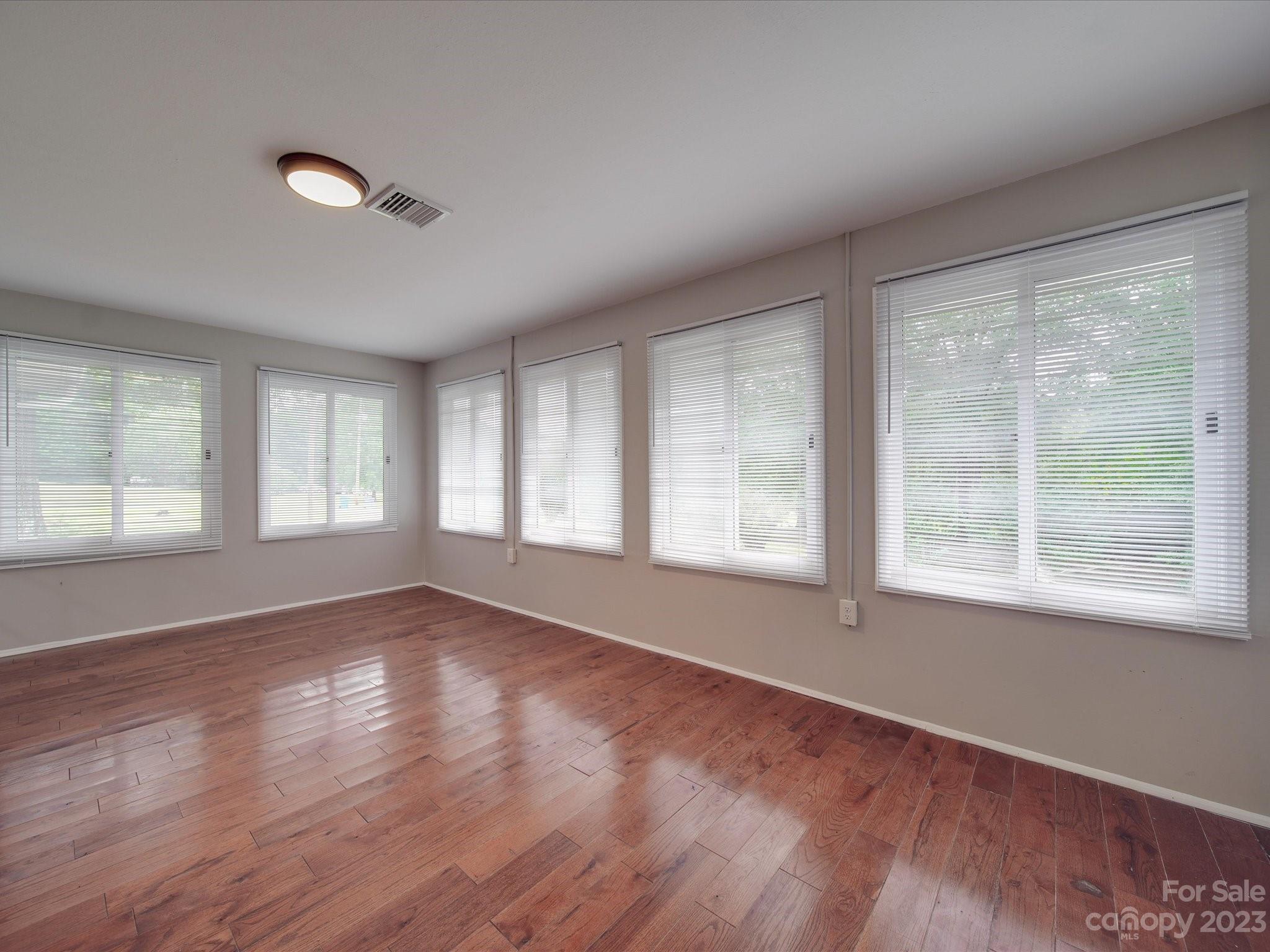 1035 Blake Road Albemarle, NC 28001 - Photo 14 of 45 a view of an empty room with wooden floor and a window