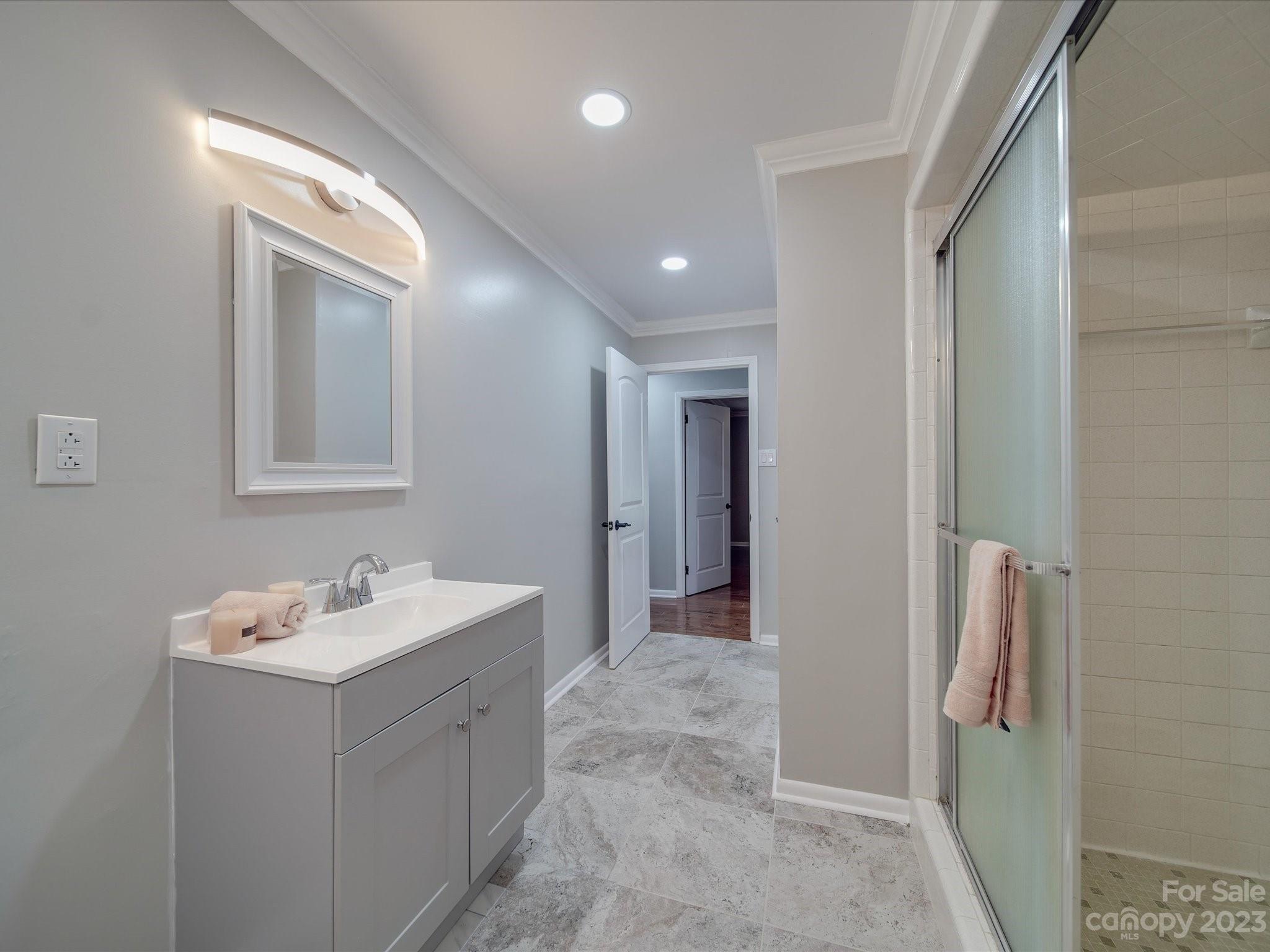 1035 Blake Road Albemarle, NC 28001 - Photo 20 of 45 a bathroom with a double vanity sink mirror and bathtub